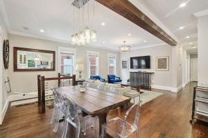 a dining room and living room with a table and chairs at Boston Escape Near T in Boston
