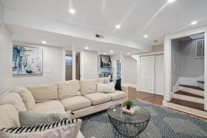 a living room with a couch and a table at Boston Escape Near T in Boston