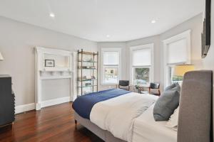 a bedroom with a bed and some windows at Boston Escape Near T in Boston +19 photos