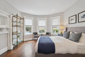 a bedroom with a large bed and some windows at Boston Escape Near T in Boston
