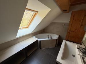a bathroom with a sink and a bath tub at Forsthaus Boberow in Rheinsberg +35 photos