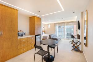a kitchen and living room with a table and chairs at Guadalupe Inn in Mexico City