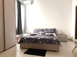 a bedroom with a bed in a white room at Grand Residence 3-Bedroom Spacious Premium Central Apartment in Is-Swieqi