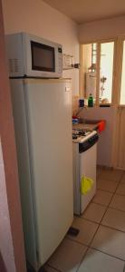 a microwave on top of a refrigerator in a kitchen at Bello Amanecer in Guanajuato