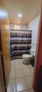 a bathroom with a toilet and a shower curtain at Bello Amanecer in Guanajuato