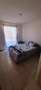 a bedroom with a bed in a room with a window at Bello Amanecer in Guanajuato
