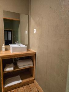 a bathroom with a sink and a mirror at Portela Room in Carnaxide