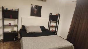 a bedroom with a bed and shelves in it at Maison Verde Madinaty in Cairo