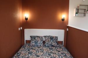 a bedroom with a bed with two pillows on it at Appartement Le Cocon des Rives in Vichy