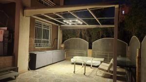 a room with two beds and a table and chairs at Maison Verde Madinaty in Cairo