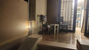 two chairs and a table in a room at Maison Verde Madinaty in Cairo