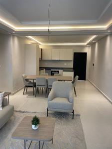 a living room with a table and chairs and a kitchen at Tanji Cliffs in Tanji