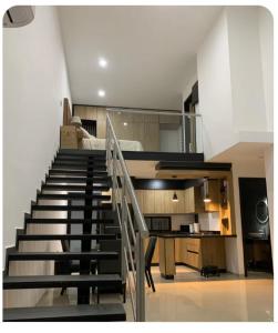 a staircase leading up to a bedroom in a house at Complejo Las Flores departamento 3 in Durango