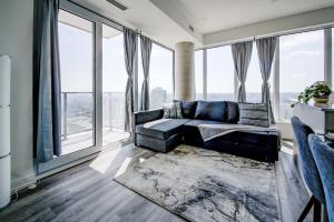 a living room with a couch and large windows at Open concept with city views in Kitchener