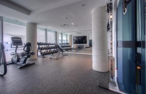 a gym with treadmills and machines in a building at Open concept with city views in Kitchener