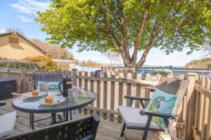 a table and chairs on a deck with a tree at 2 Bed in Brixham oc-57244 in Brixham