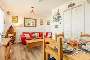 a living room with a red couch and a table at 2 Bed in Brixham oc-57244 in Brixham