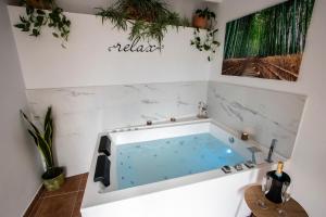 a hot tub in a bathroom with white walls at La Cambra casa rural in Potríes +49 photos