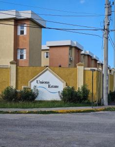 a sign on the side of a building at Leemclean gated vacation home in Spanish Town