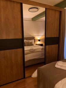a bedroom with a large mirror and a bed at ENA Lux in Novi Pazar