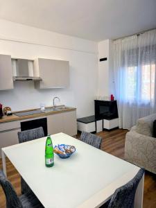 a white table in a kitchen with a bottle on it at Chianciano Lettings -Room and Apartments- in Chianciano Terme