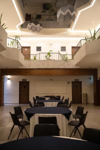 a row of tables and chairs in a room at Hotel Melanie Tepic in Tepic