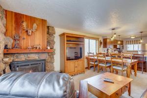 a living room with a fireplace and a dining room at Winter Park Condo w/ Pool + Ski Shuttle Access! in Winter Park