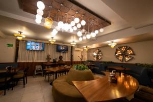 a restaurant with tables and chairs and a person in the background at Hotel Melanie Tepic in Tepic