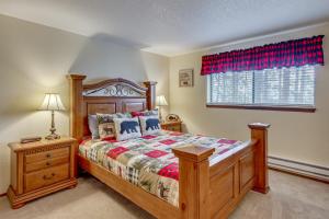 a bedroom with a wooden bed and a window at Winter Park Condo w/ Pool + Ski Shuttle Access! in Winter Park +27 photos