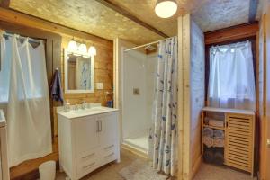 a bathroom with a white sink and a shower at Rustic Poland Vacation Rental w/ Waterfront Deck! in Poland +20 photos