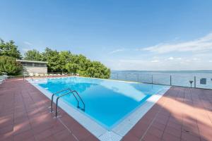 a swimming pool with a view of the water at MGH- Lake Serenity Apartment in Padenghe sul Garda