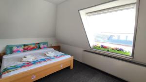 a small bedroom with a bed and a window at Birken Loft am Meer in Neustadt am Rübenberge +34 photos