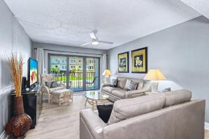 a living room with a couch and a table at Madeira Place 205 in St. Pete Beach