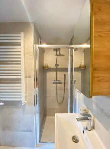 a bathroom with a shower and a sink at Kryształowa 47/7 in Piechowice +6 photos