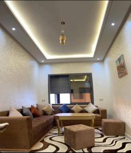 a living room with a couch and a table at Apparemment in Agadir