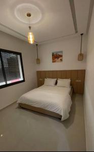 a bedroom with a large white bed in it at Apparemment in Agadir