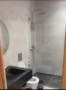a bathroom with a sink and a toilet and a shower at Apparemment in Agadir