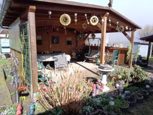 a pergola with a table and chairs in a yard at Ferienwohnung Alte Post in Knorrendorf