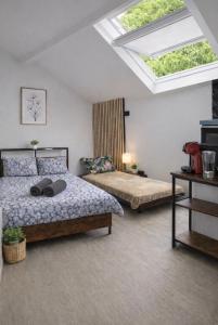 a bedroom with two beds and a skylight at Superbe studio top emplacement in Villeneuve-Saint-Georges