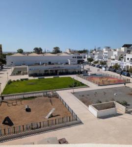 a view of a building with a park in front of it at Island Dream Apartment in Olhão