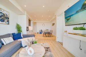 a living room with a couch and a table at Modern Penthouse in Central KW in Kitchener