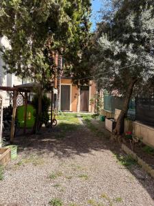 a yard with trees and a house with a building at Palazzo Degli Affreschi - Luxury Villa Verona in Verona
