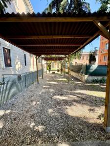 a wooden pergola in front of a building at Palazzo Degli Affreschi - Luxury Villa Verona in Verona +6 photos
