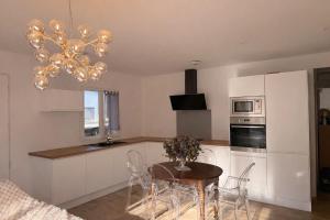 a kitchen with a table and chairs and a chandelier at Entire house 6 guests Mountain view in Luri