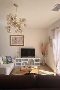 a living room with a couch and a flat screen tv at Entire house 6 guests Mountain view in Luri