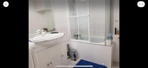 a white bathroom with a sink and a mirror at Studio cosy in Boutx