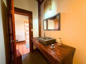 a bathroom with a wooden sink and a mirror at Vaihu Nui Bungalow-Glamping in Hanga Roa