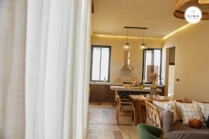 a living room and kitchen with a couch and a table at Villa NDOL'AM in Ebomé +39 photos