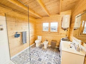 a bathroom with a shower and a toilet and a sink at Nido de mar & Nido de Paola in Mazo +65 photos