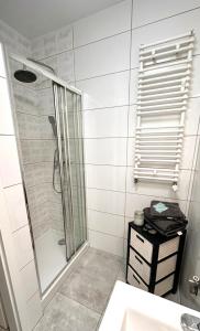 a bathroom with a shower and a sink at Apartament Wiosenna in Białystok +11 photos